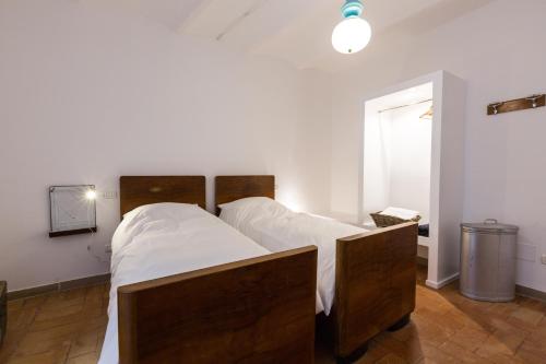 a bedroom with two beds with white sheets at Room En Suite la Corte Assisi in Assisi