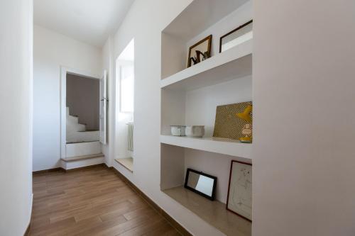 a living room with white walls and wooden floors at Room En Suite la Corte Assisi in Assisi