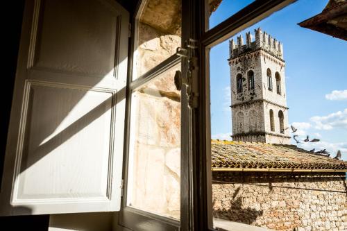 a window view of a clock tower from a building at Room En Suite la Corte Assisi in Assisi