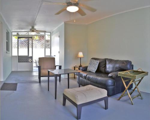 a living room with a leather couch and a table at One Ocean - A 1101 in Sarasota
