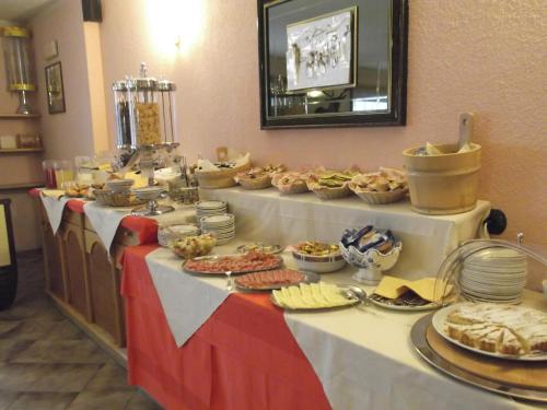 a buffet with food on a table in a room at Hotel Adele in Livigno