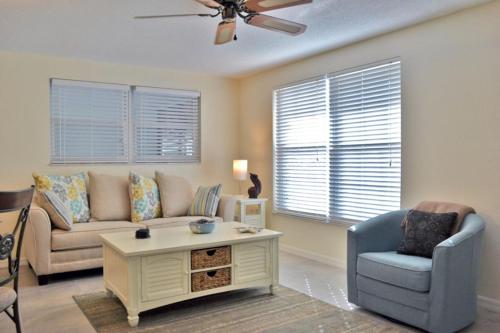 a living room with a couch and a chair at One Ocean - A 1101 in Sarasota