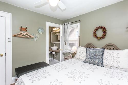 a bedroom with a white bed with a wreath on the wall at Ambiance By The Falls B&B in Niagara Falls