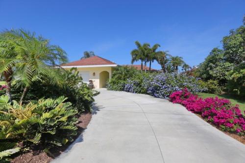a walkway in front of a house with flowers at Sarasota - Dunmore 8730 in Sarasota