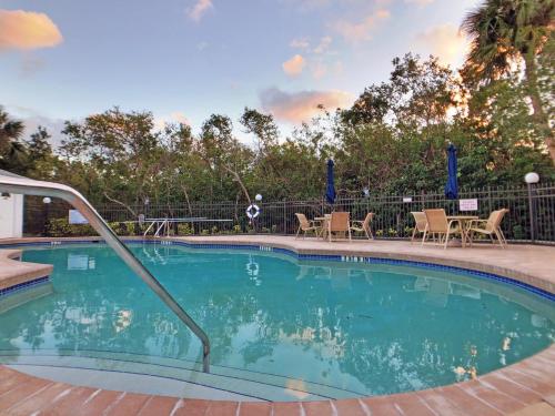 a large swimming pool with chairs and a table at Holmes Beach - Mangroves 3607 #208 in Holmes Beach