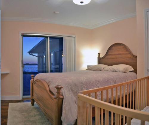 a bedroom with a bed and a large window at Sarasota - Dunmore 8730 in Sarasota