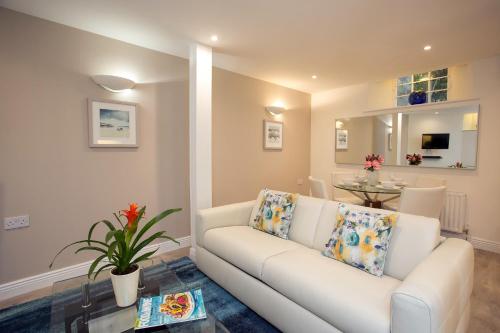 a living room with a white couch and a table at Ballsbridge Apartments in Dublin
