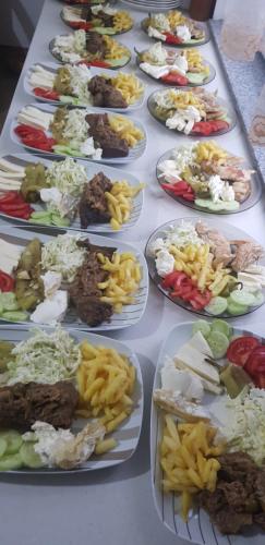 a table full of plates of different types of food at PROKLETIJE eko katun Vusanje in Gusinje