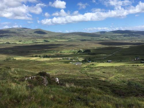 a field of grass with mountains in the background at Glenview Lodge in Portree
