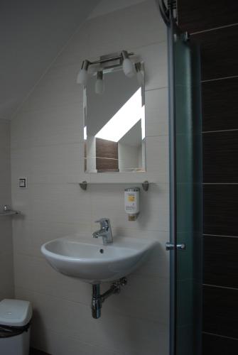a bathroom with a sink and a mirror at Penzion Na Dědině in Mutěnice