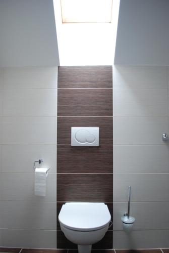 a bathroom with a toilet and a window at Penzion Na Dědině in Mutěnice