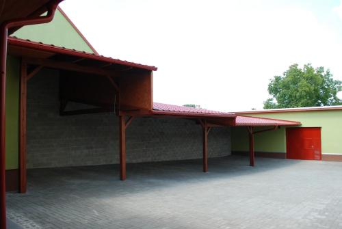 a building with awnings on the side of it at Penzion Na Dědině in Mutěnice