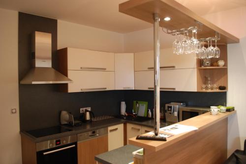 a kitchen with white cabinets and a chandelier at Penzion Na Dědině in Mutěnice