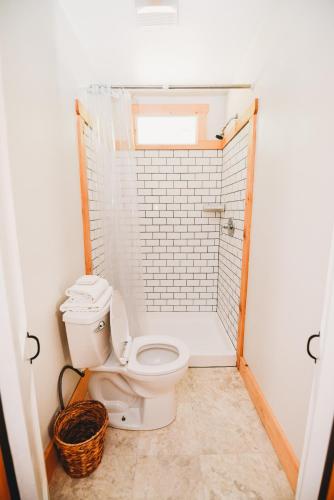 a white bathroom with a toilet and a shower at Rainbow Mountain Resort - LGBTQ Friendly in East Stroudsburg
