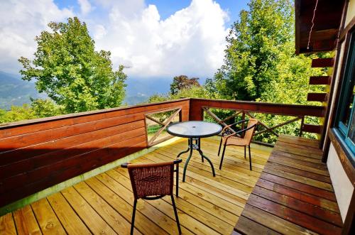 a wooden deck with a table and chairs on it at Shiyai Taoyuan in Renai