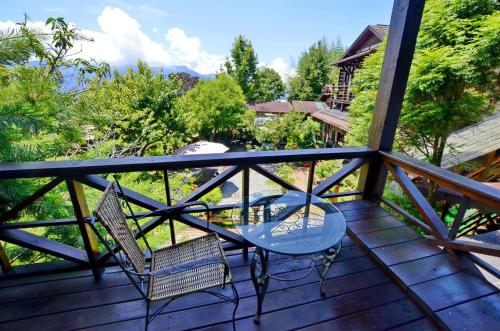 a table and two chairs on a deck with a view at Shiyai Taoyuan in Renai