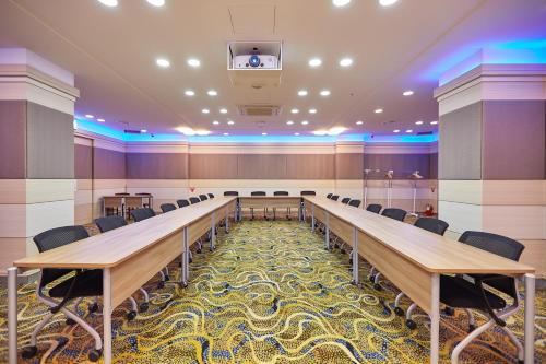 a large conference room with a long table and chairs at Towerhill Hotel in Busan