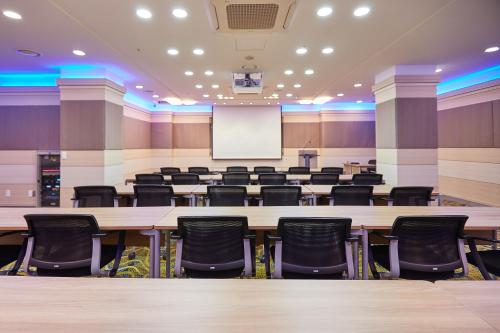 a conference room with a large table and chairs at Towerhill Hotel in Busan