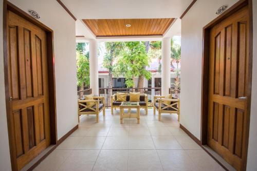 a hallway with two doors and a table and chairs at Sur Beach Resort Boracay in Boracay