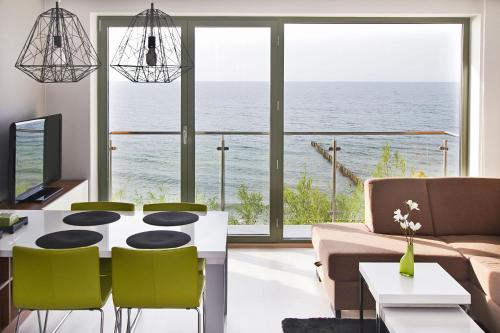 a living room with a view of the ocean at Apartamenty Na Klifie in Ustronie Morskie