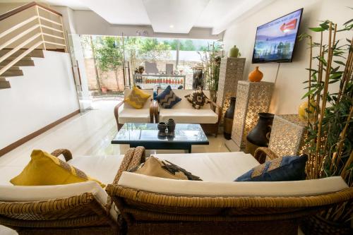 a living room with two couches and a table at Sur Beach Resort Boracay in Boracay
