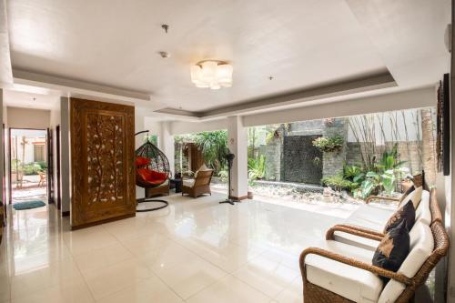 a living room with chairs and a large glass door at Sur Beach Resort Boracay in Boracay