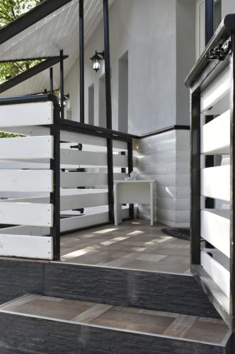 a patio with a white and black fence at Cazare Moldi Btt in Câmpulung Moldovenesc