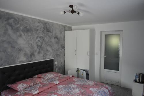 a bedroom with a bed and a ceiling fan at Cazare Moldi Btt in Câmpulung Moldovenesc