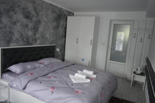 a bedroom with a bed with two towels on it at Cazare Moldi Btt in Câmpulung Moldovenesc