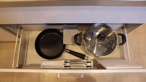 a pot and pans sitting on a shelf at beautiful Mt.Fuji A in Fujikawaguchiko