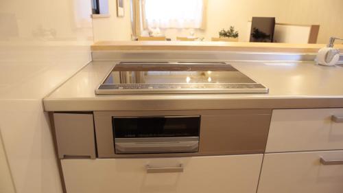 a kitchen with a stove top oven on a counter at beautiful Mt.Fuji A in Fujikawaguchiko