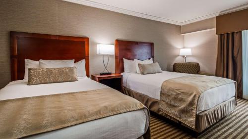 a hotel room with two beds and two lamps at Inn at Mendehall in Mendenhall
