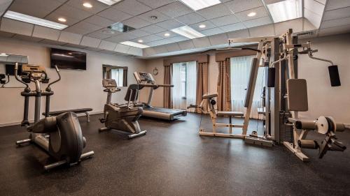 a gym with treadmills and machines in a room at Inn at Mendehall in Mendenhall