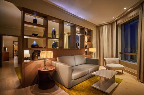 a living room with a couch and a chair at Hyatt Regency Belgrade in Belgrade