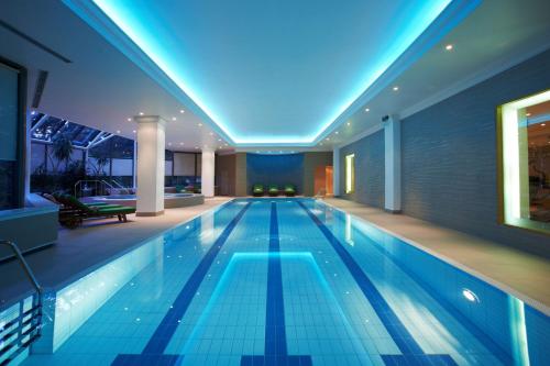 a large swimming pool in a large room at Hyatt Regency Belgrade in Belgrade