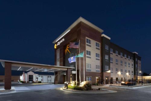 a hotel building with an american flag on it at La Quinta by Wyndham Wichita Airport in Wichita