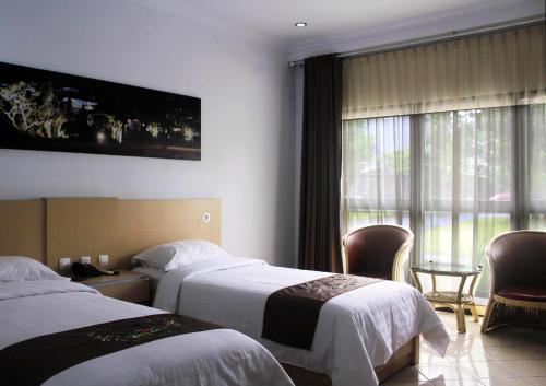 Posteľ alebo postele v izbe v ubytovaní Mandalawangi Hotel