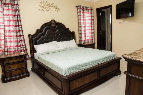 a bedroom with a bed and a television in it at Hamptons at Fairway across from AC Marriott Unit No3 in Kingston