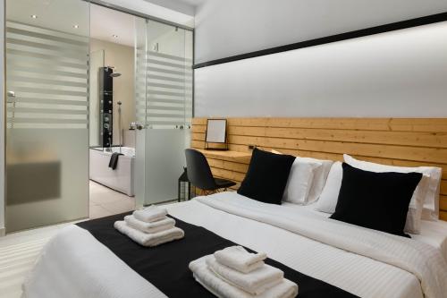 a bedroom with a large bed with towels on it at Old Town Senses Boutique Hotel in Rhodes Town