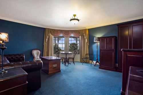 a living room with a couch and a table at Quality Hotel Bentinck in Portland