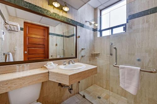 a bathroom with a sink and a mirror at Quality Inn Aguascalientes in Aguascalientes