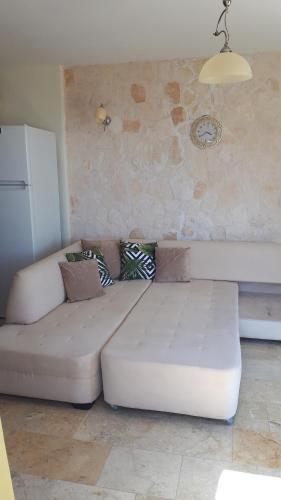 a white couch sitting in a living room at Carla Apart Kalkan in Kalkan