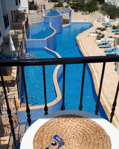 a view of a swimming pool from a balcony at Carla Apart Kalkan in Kalkan