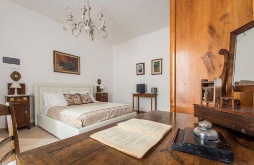 a bedroom with a bed and a table with a book at A casa di Irma e Nilo in Palaia