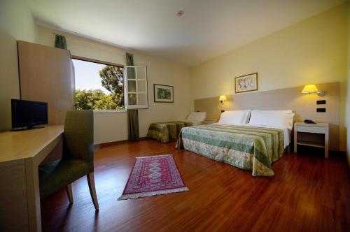 Postel nebo postele na pokoji v ubytování Hotel Borgo Verde