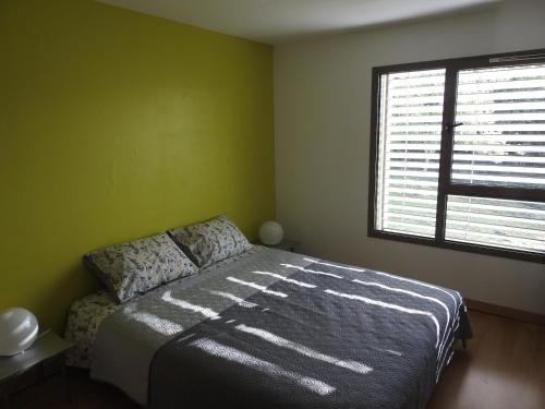 a bedroom with a bed and a window at Le Cube in Nayemont-les-Fosses