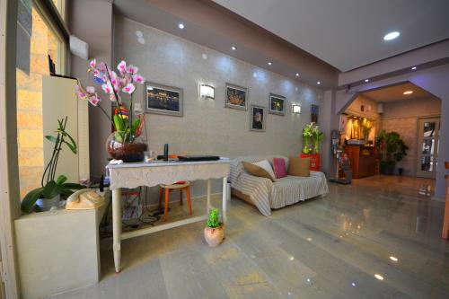 a living room with a couch and a table at Bikakis Family Apartments in Kissamos