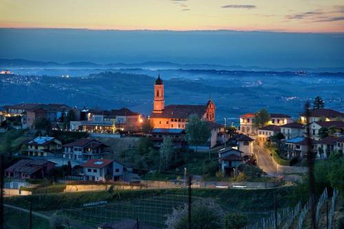 a small town with a clock tower at night at Ciabot Apartments in Treiso
