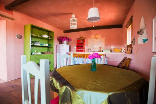 a kitchen with a table with a vase of flowers on it at Hubara Retreat in Charco del Palo