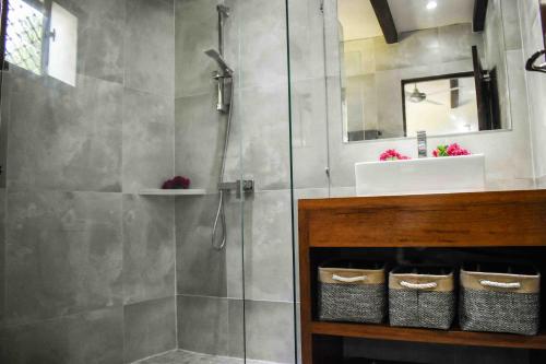 a bathroom with a shower and a sink at Harbour Views in Port Vila